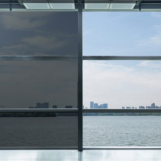 A panoramic cityscape seen through a spacious window, showcasing the urban landscape in all its grandeur.